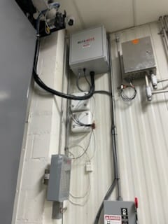 Garage door opener motor and rail mounted at the ceiling